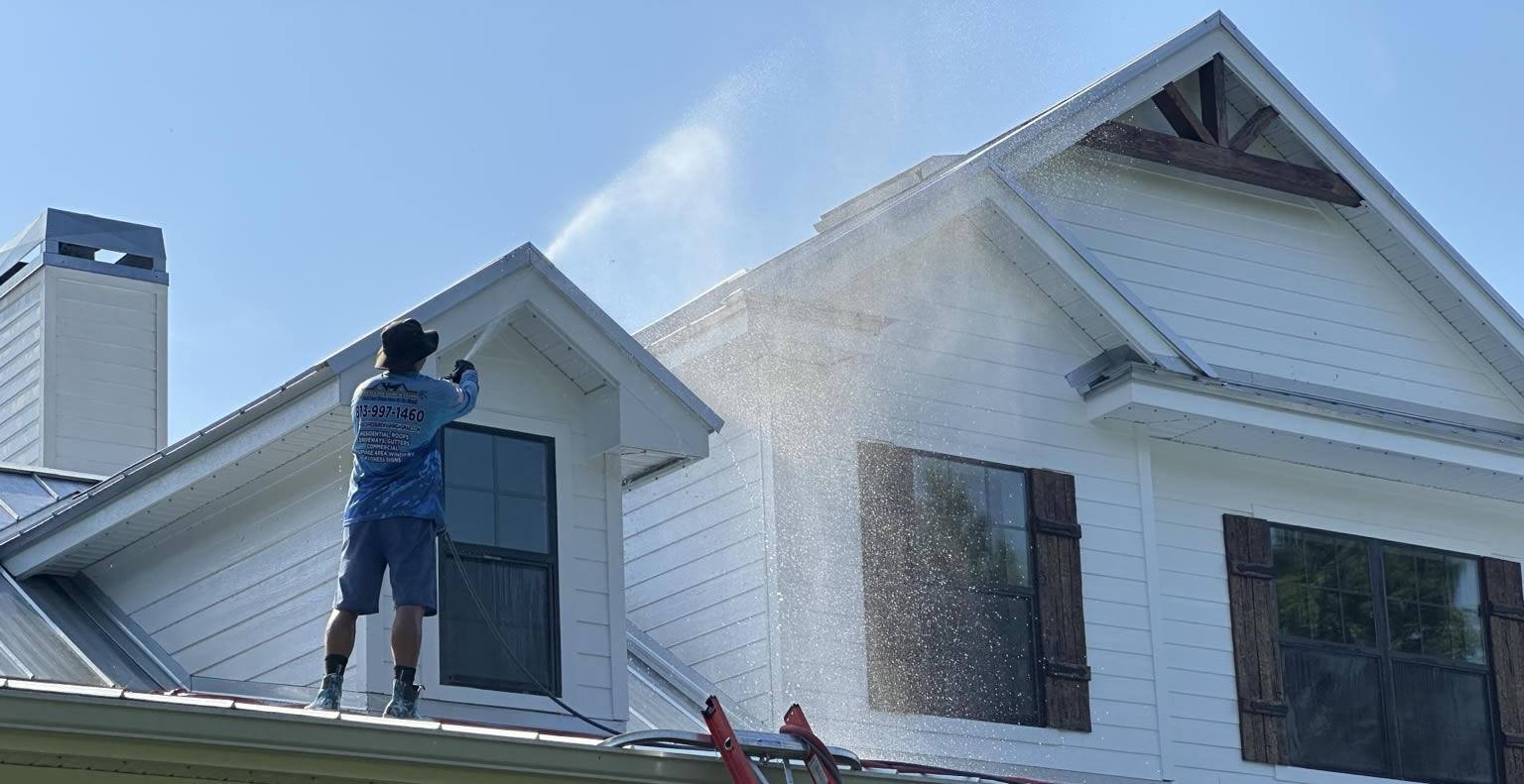 Tecnician Soft Washing a Roof