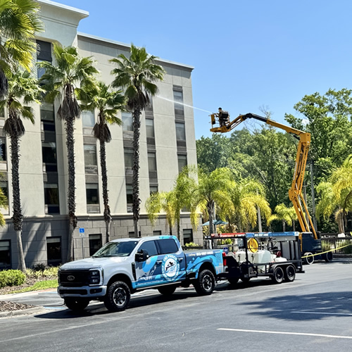 Commercial building pressure washing boom lift
